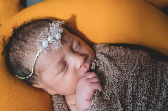 Black and white newborn portrait of two faces sitting at the Clinton studio.