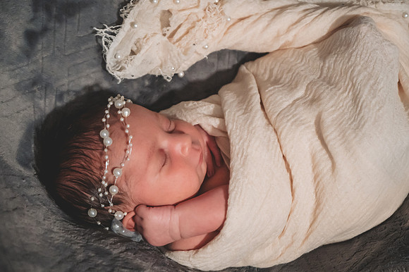 Newborn session at Clinton studio featuring a smiling male child.