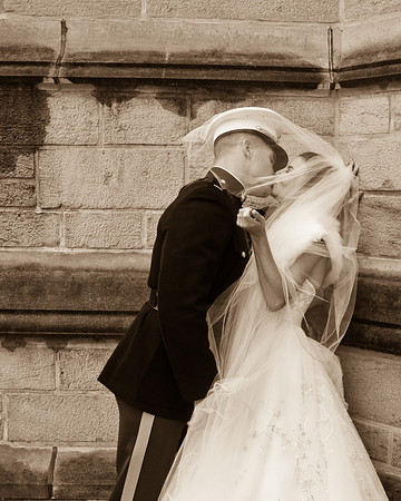 military wedding bride and groom kissing by a wall outside by NJ Wedding Photographer