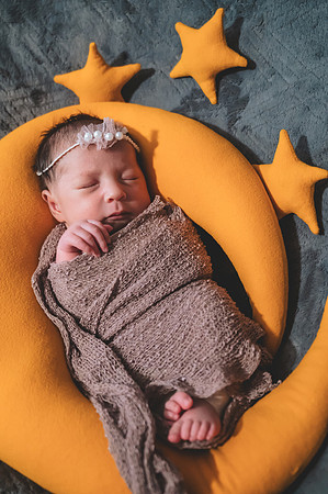 Colorful newborn portrait with eyes open, captured at the Clinton studio.