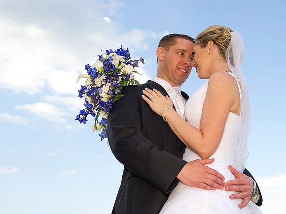 bride and groom embrace beach wedding by NJ Wedding Photographer