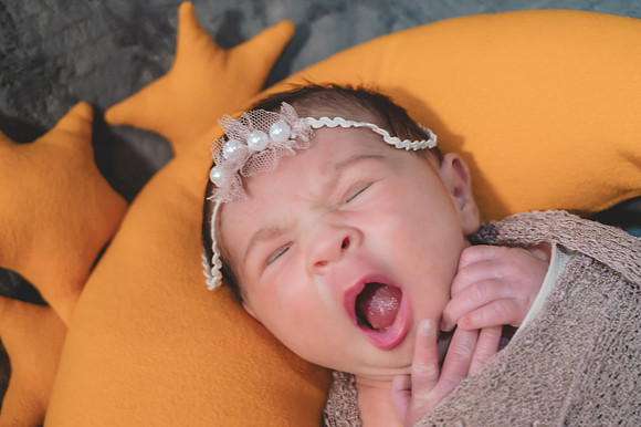 Newborn portrait with eyes open in a basket, captured at the Clinton studio.