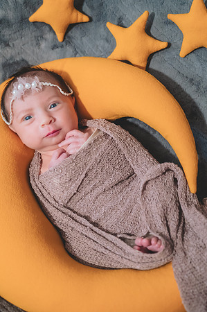 Newborn portrait with bokeh effect, eyes open at the Clinton studio.
