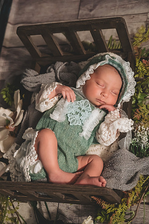 Colorful newborn profile portrait at Clinton studio featuring a kneeling pose.