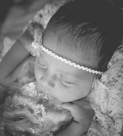 High key black and white newborn portrait at Clinton studio with blond hair and eyes open.