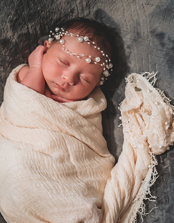 Newborn session at Clinton studio featuring two faces in profile view.