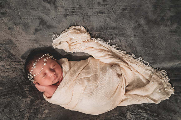 Colorful newborn portrait at Clinton studio featuring a smiling male child.