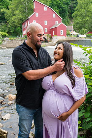 Black and white maternity portrait of a smiling couple with blond hair.