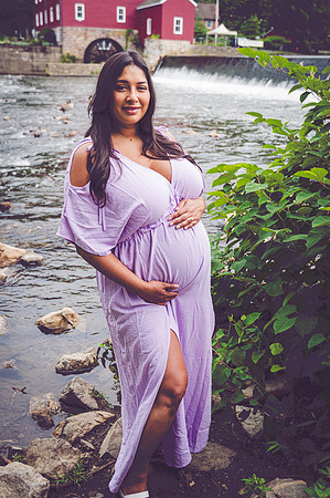 Another black and white maternity portrait of a couple at a waterfall.