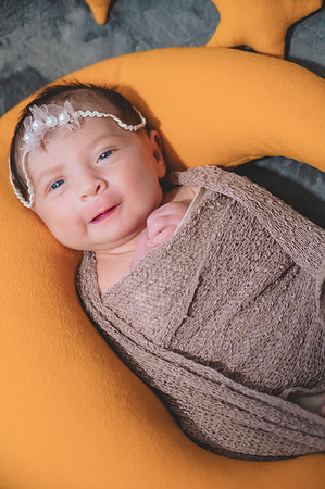 Another black and white portrait of a newborn lying down with eyes open at the Clinton studio.