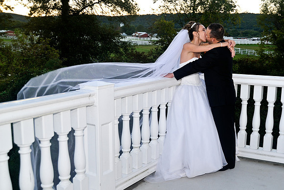 bride and groom kissing on balcony by NJ Wedding Photographer