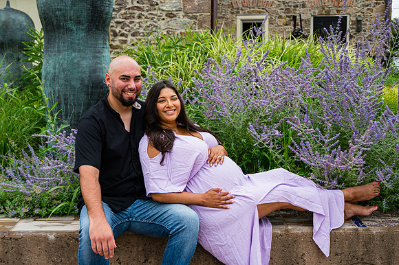 Colorful newborn session at Clinton studio featuring a kneeling male child.