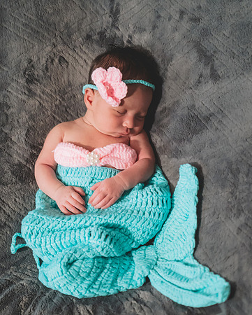 Colorful newborn session at Clinton studio in a basket with a smile.