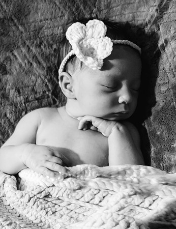 Black and white newborn session at Clinton studio with a smiling male child.