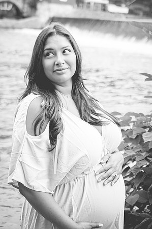 Black and white newborn portrait in a basket at Clinton studio with a smile.
