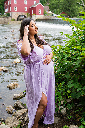 Maternity portrait with a smiling male by a waterfall.
