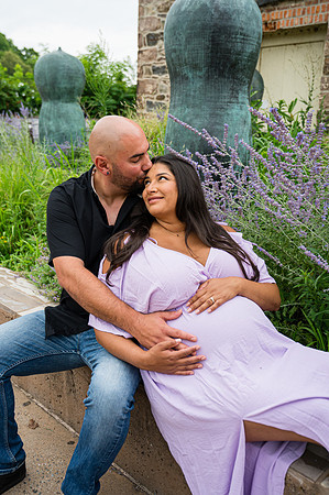 Sitting portrait of a pregnant female with complementary colors and eyes open.