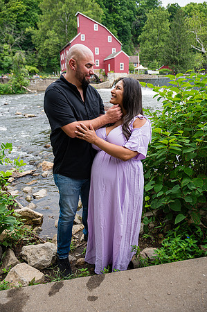 Maternity portrait of a smiling female in profile view.