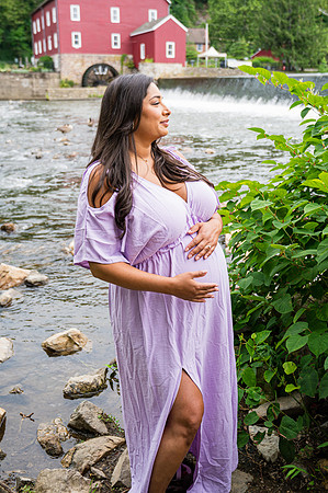 Maternity session by a river with one male's eyes closed.