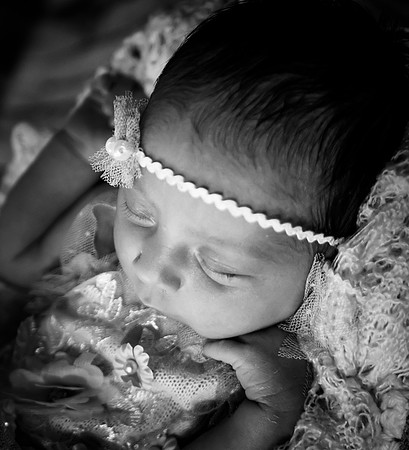 Black and white portrait of a smiling pregnant female.