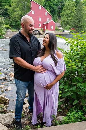 Black and white wedding maternity portrait featuring a smiling couple.