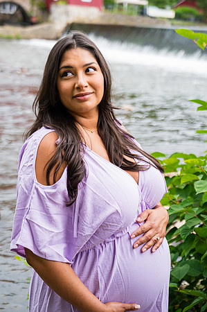 Portrait of a smiling pregnant female with complementary colors.