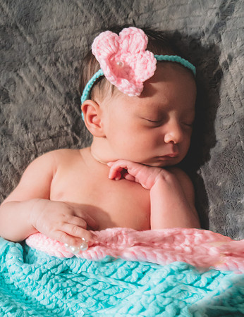 Black and white newborn session at Clinton studio with a smiling male child.