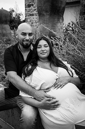 Maternity portrait by a waterfall with complementary colors.