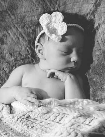 Newborn session at Clinton studio with a smiling face.