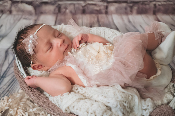 Colorful newborn session at Clinton studio with a kneeling pose.