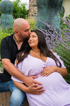 Sitting profile portrait of a pregnant female with brown hair and complementary colors.