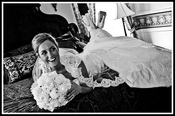 bride laying on bed in wedding dress by NJ Wedding Photographer