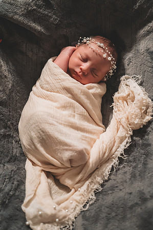 Colorful newborn session at Clinton studio with a smiling male child.
